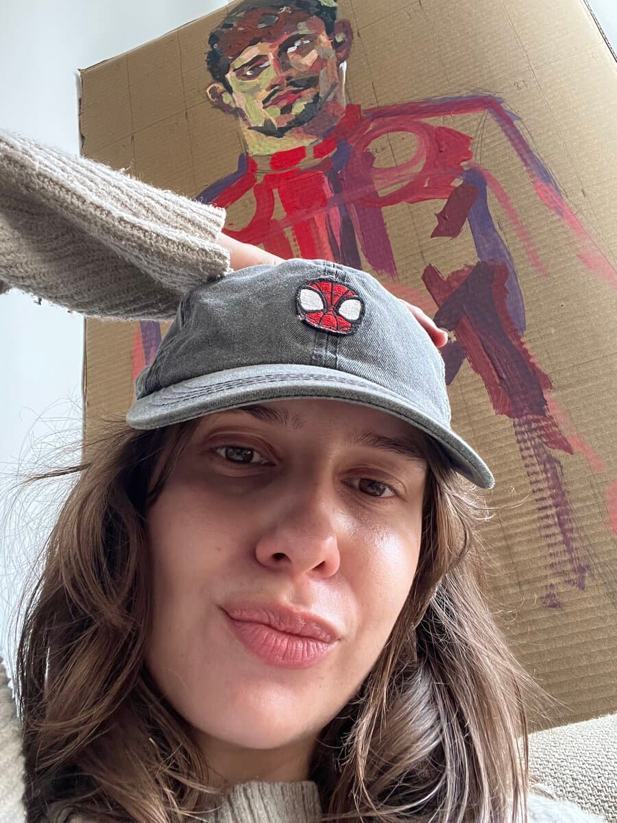 Me holding up my painting of Charles Leclerc
