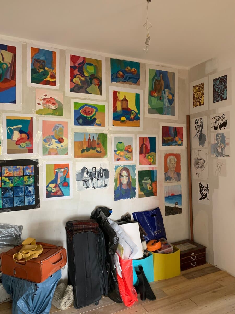 A wall at my parents' home covered with my paintings