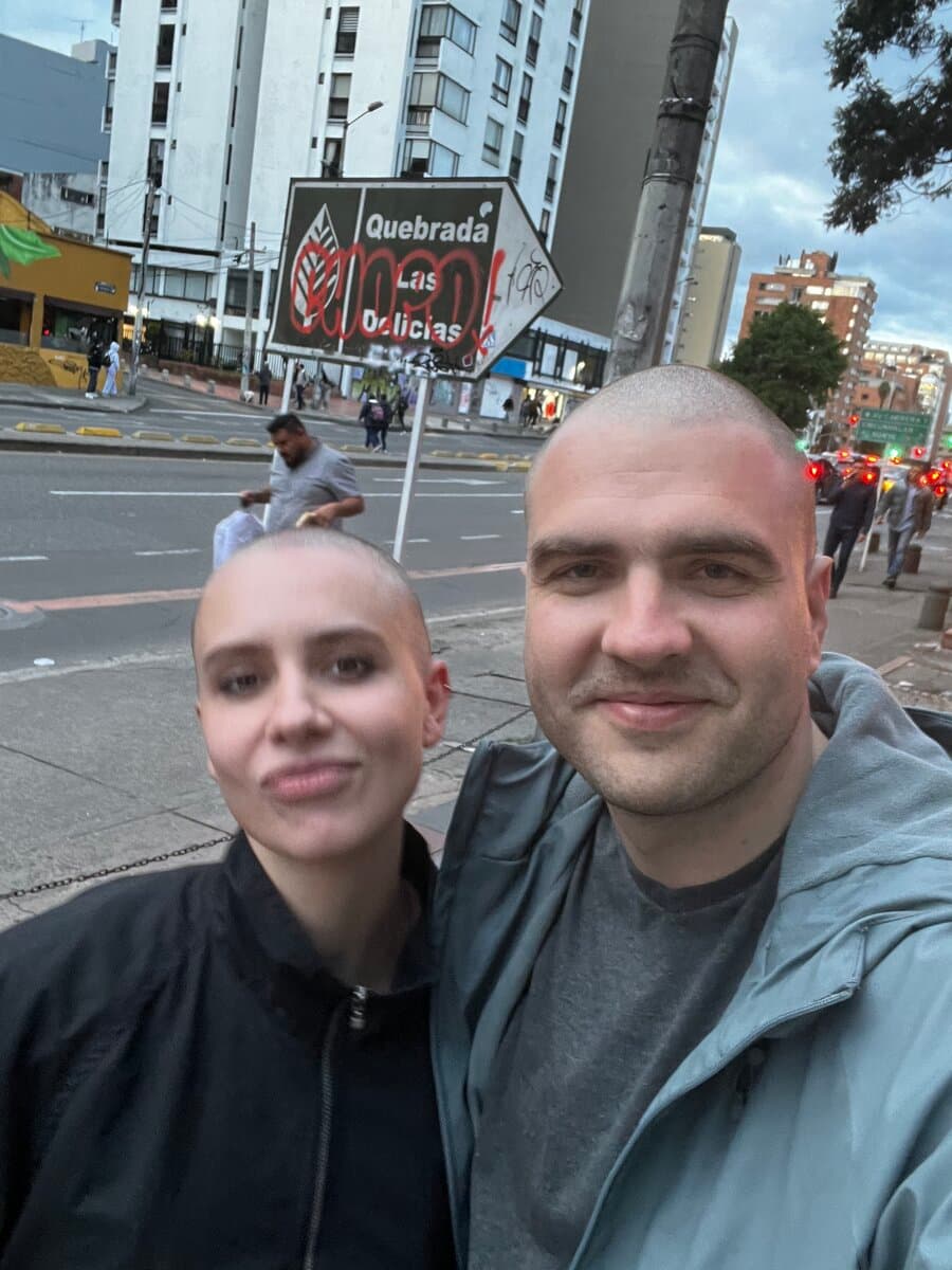 Me and my boyfriend on a street in Bogotá, both with our heads shaved