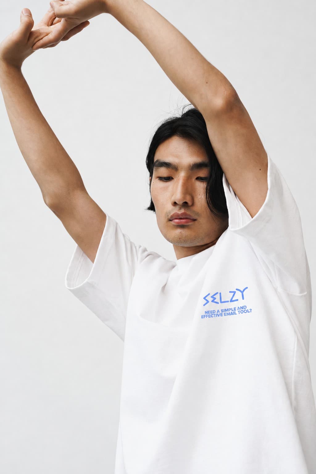 Selzy T-shirt from the front, a man stretching his arms over his head